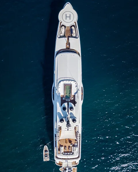Drone view of a luxury megayacht with tender
